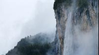 Epic Waterfall In Cloudy Mountains